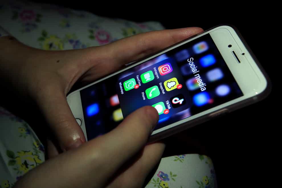 Parents are being encouraged to talk to their children about social media at a young age after new research found girls are negatively affected earlier than boys (Peter Byrne/PA)