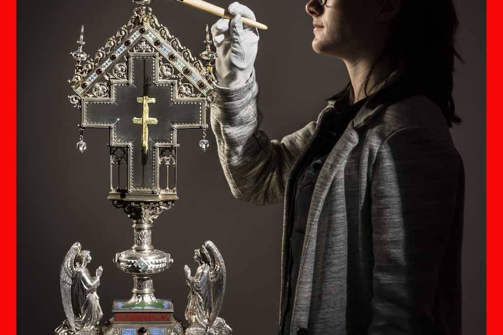 Special collections manager Dr Hannah Thomas cleans a True Cross relic, displayed in an ornate reliquary case made of silver gilt, precious stones and crystal, at The Bar Convent Living Heritage Centre in York, as the convent marks Easter with the discovery of previously unseen authentication and provenance documents (PA)
