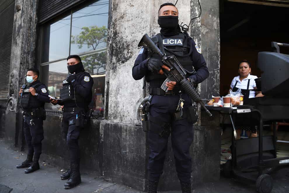 Heavily armed police guard the streets in down town San Salvador, El Salvador, Sunday, March 27, 2022. El Salvador’s congress has granted President Nayib Bukele request to declare a state of emergency, amid a wave of gang-related killings over the weekend. (AP Photo/Salvador Melendez)