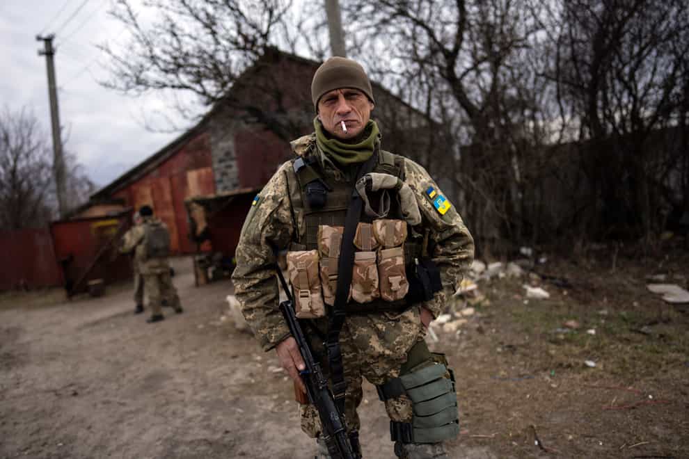 A soldier smokes a cigarette near the frontline in Brovary, on the outskirts of Kyiv (Rodrigo Abd/AP)
