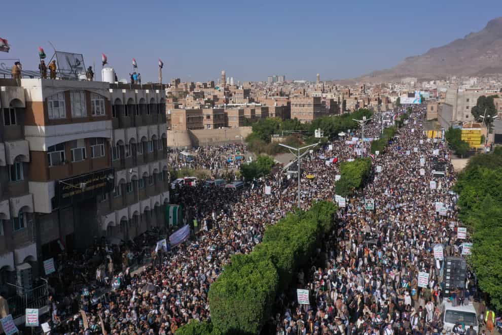 Houthi supporters attend a rally during the seventh anniversary of the Saudi-led coalition’s intervention in Yemen’s war in Sanaa (AP)