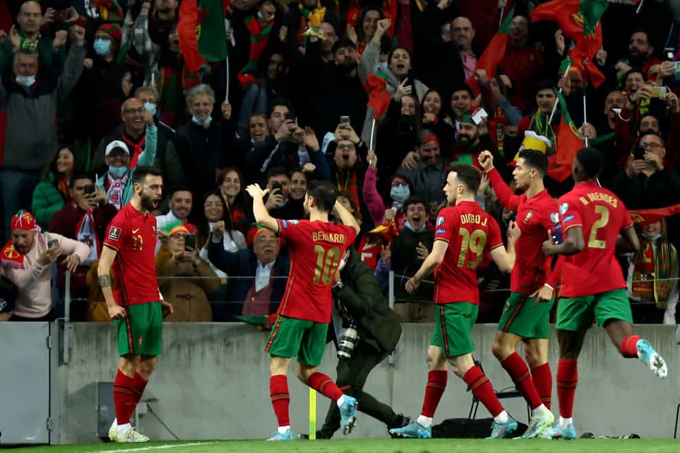 Bruno Fernandes, left, celebrates after scoring in Portugal’s World cup play-off victory over North Macedonia (Luis Vieira/AP).