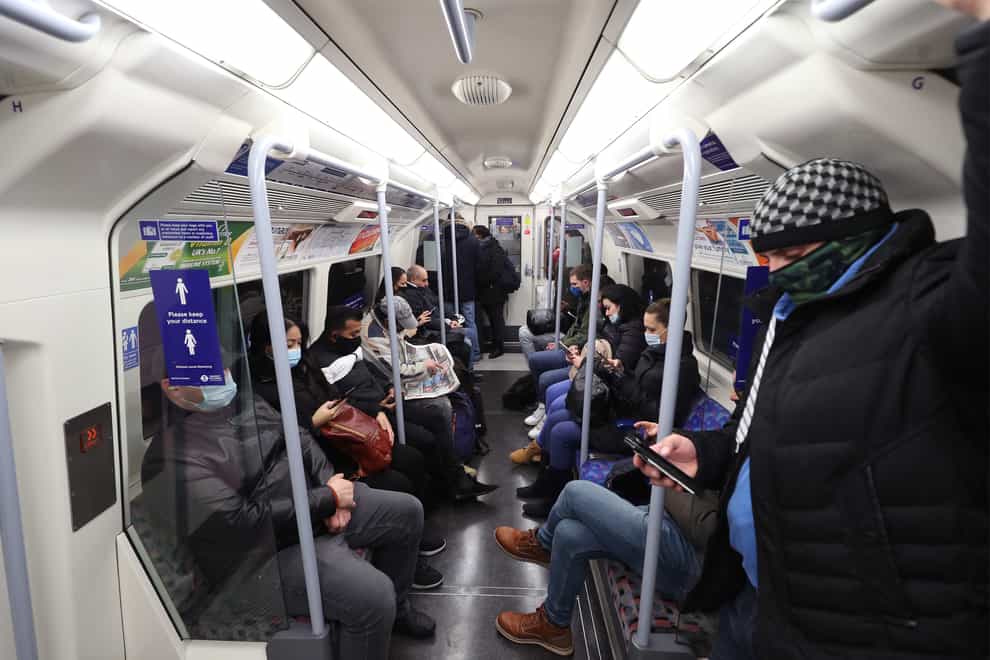Commuters travel on a Jubilee Line underground train during the morning rush hour in London (PA)