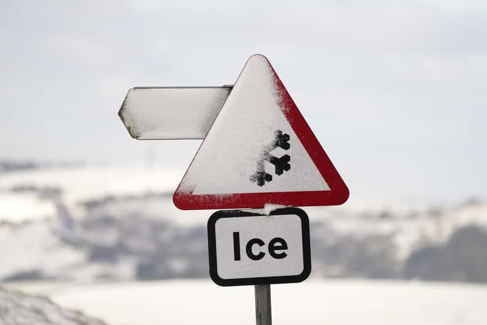 A snowy sign in Saddleworth near Oldham (PA)