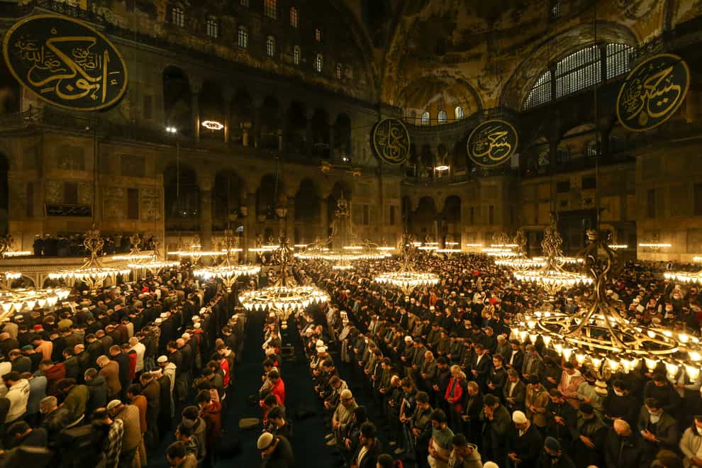 Muslim worshippers perform a night prayer called ‘tarawih’ during the eve of the first day of the Muslim holy fasting month of Ramadan in Turkey at Hagia Sophia mosque in Istanbul, Turkey, Friday, April 1, 2022. (AP Photo/Emrah Gurel)