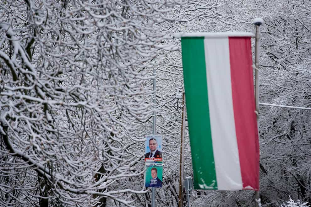 Election posters and the Hungarian flag outside a polling station in Budapest (Petr David Josek/AP)