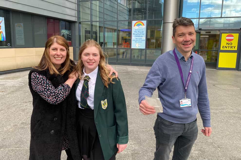 Schoolgirl Beth McKenzie and her mother Clare with Roddy O’Kane, the surgeon who removed a tumour the size of an orange from the youngster’s brain (NHS Greater Glasgow and Clyde/PA)