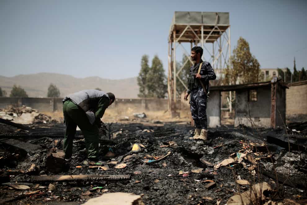 Yemeni police inspect the site of Saudi-led air strikes targeting two houses in Sanaa (Hani Mohammed/AP)