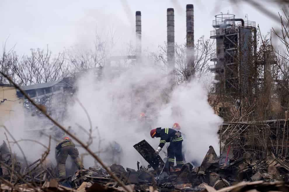 Ukrainian firefighters work at the scene of a destroyed building after shelling in Odesa (Petros Giannakouris/AP)