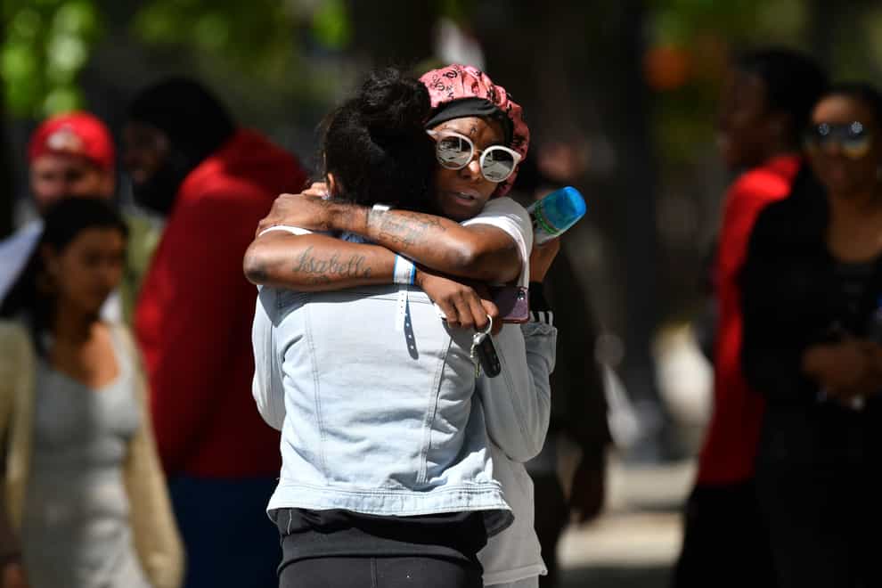 Two women hug each other at the scene of a mass shooting in Sacramento (Jose Carlos Fajardo/Bay Area News Group/AP)