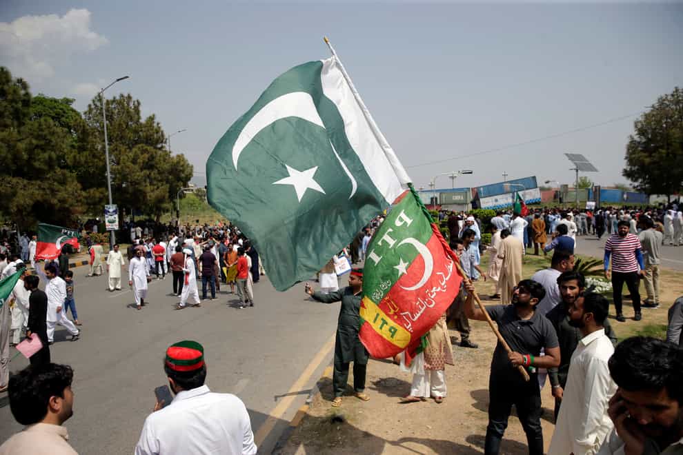 Supporters of ruling party Pakistan Tehreek-e-Insaf (PTI) gather during a protest in Islamabad, Pakistan (Rahmat Gul/AP)
