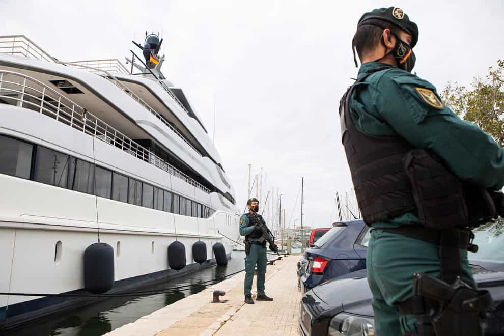 Civil Guards stand by the yacht called Tango in Palma de Mallorca on Monday April 4 2022 (Francisco Ubilla/AP)