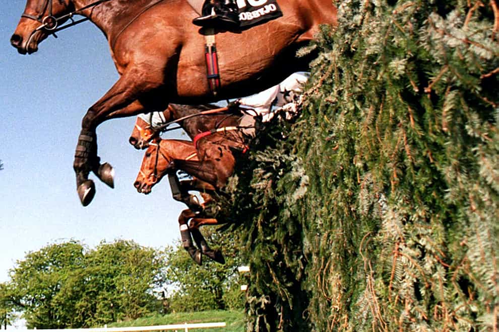 Bobbyjo and Paul Carberry jump the open ditch at Aintree (John Giles/PA)