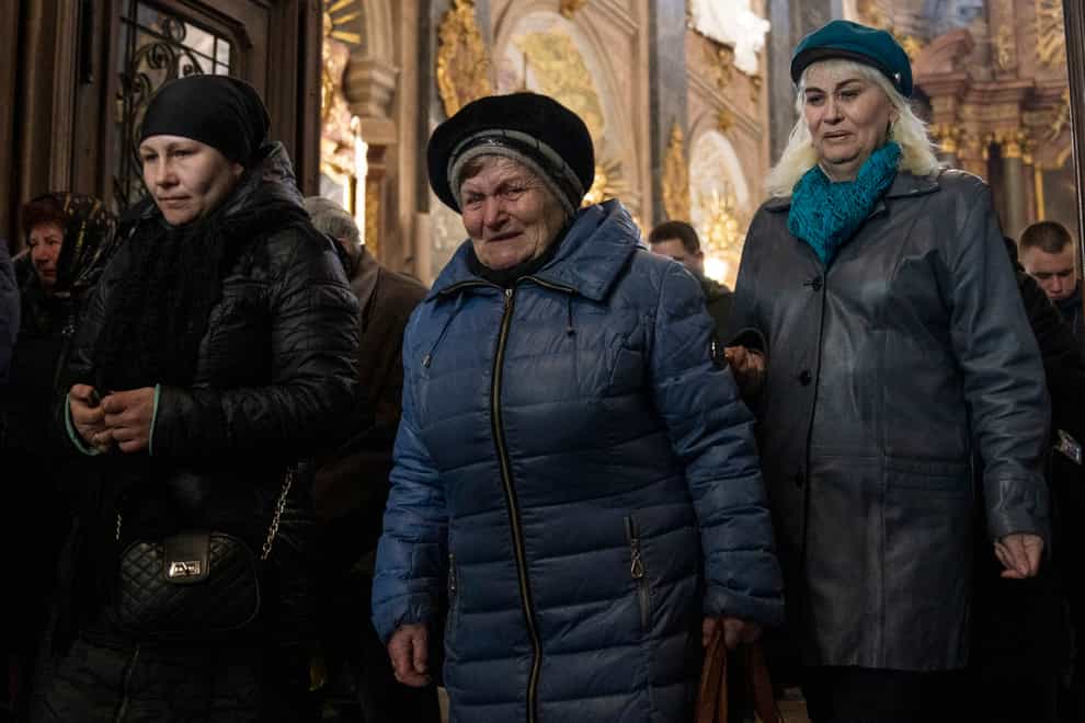 Women mourn during the funeral of 44-year-old soldier Tereshko Volodymyr, and 41-year-old soldier Simakov Oleksandr, after he was killed in action, at the Holy Apostles Peter and Paul Church in Lviv, western Ukraine, on Monday April 4 2022 (Nariman El-Mofty/AP)