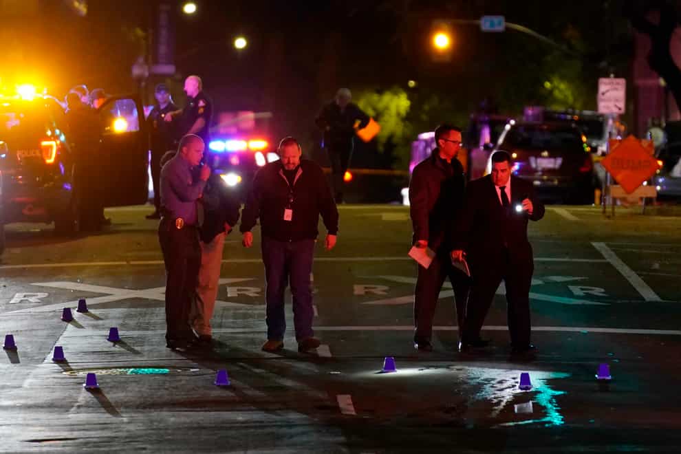 Authorities search area of the scene of a mass shooting (Rich Pedroncelli/AP)