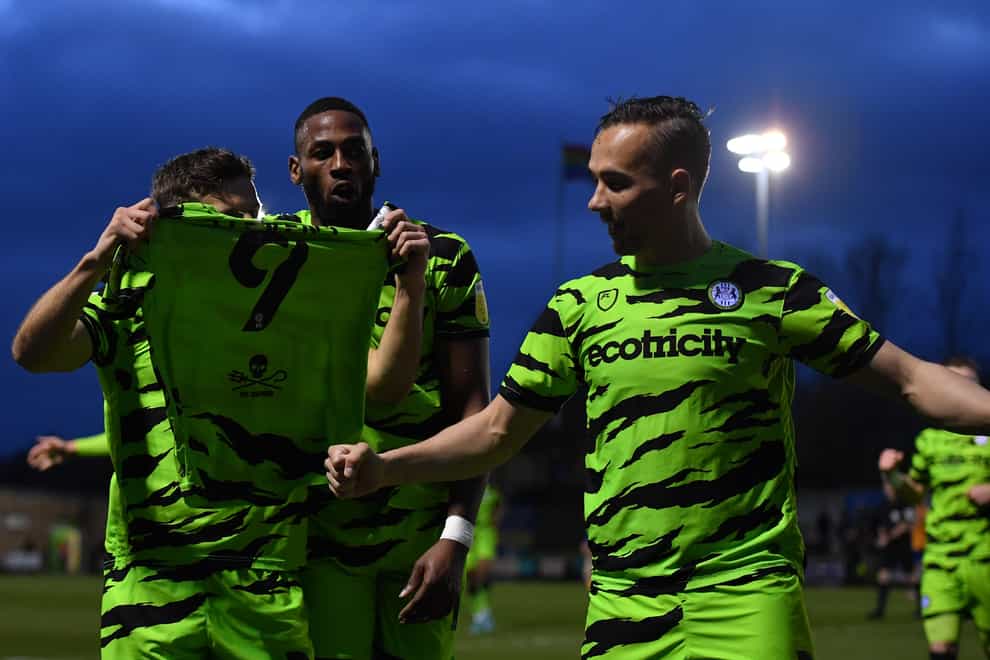 Forest Green Rovers’ Josh March holds up the shirt of team-mate Matty Stevens as he celebrates his goal (Simon Galloway/PA)
