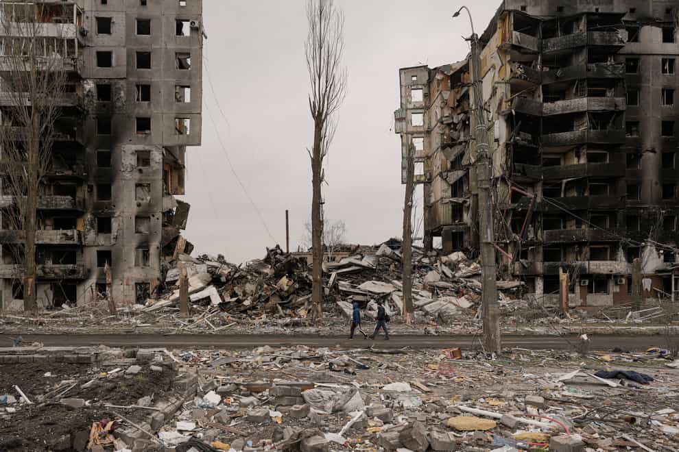 People walk by an apartment building destroyed during fighting between Ukrainian and Russian forces in Borodyanka, Ukraine (AP Photo/Vadim Ghirda)
