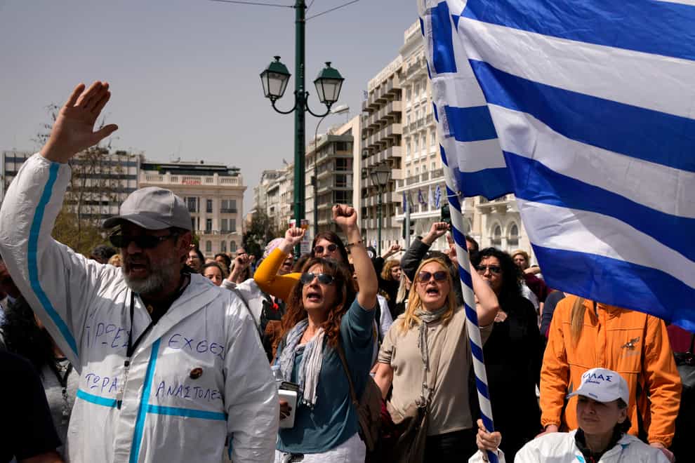 Health workers shout slogans as they march during a 24-hour nationwide strike in central Athens, Greece, on Wednesday April 6 2022 (Thanassis Stavrakis/AP)