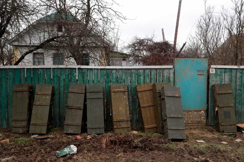 Ammunition crates left behind by retreating Russian troops are leant against a fence in the village of Andriivka, Ukraine, on Wednesday April 6 2022 (Adam Schreck/AP)