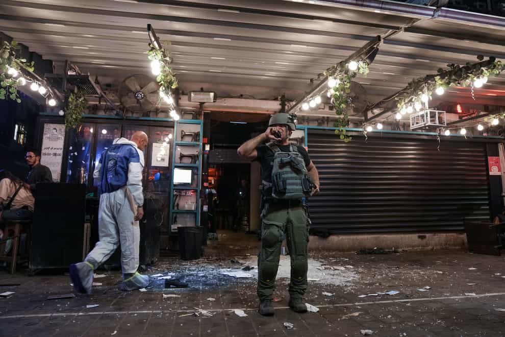 Israeli police inspect the scene of a shooting attack In Tel Aviv (Ariel Schalit/AP)