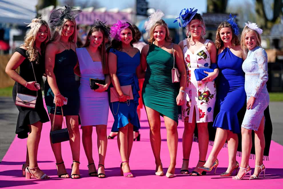 Racegors pose for photographers at Ladies Day at Aintree Racecourse, Liverpool (David Davies/PA)