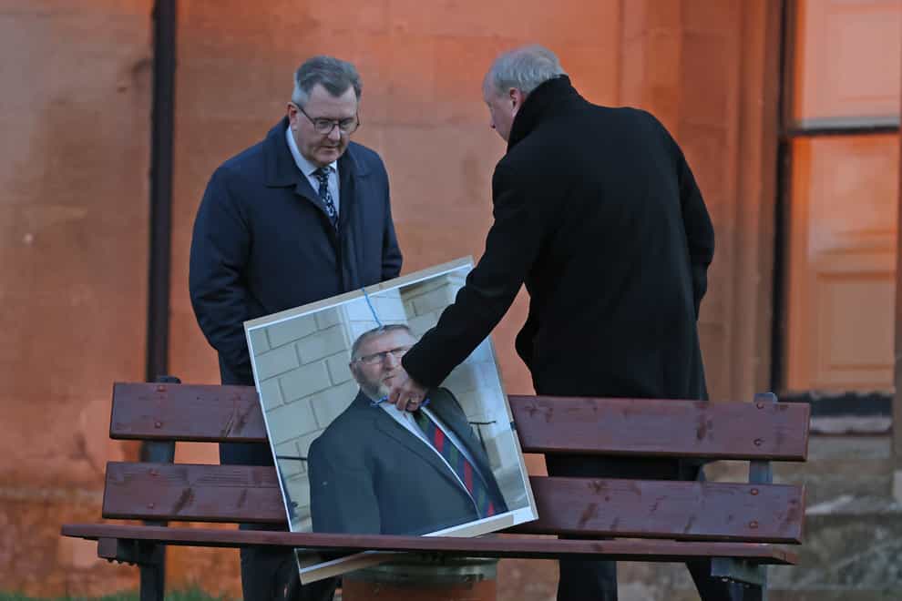 Jim Allister (right) and DUP leader Sir Jeffrey Donaldson remove a poster of the leader of the Ulster Unionist Party, Doug Beattie, during a rally in opposition to the Northern Ireland Protocol at Brownlow House in Lurgan, Co Armagh (Liam McBurney/PA)