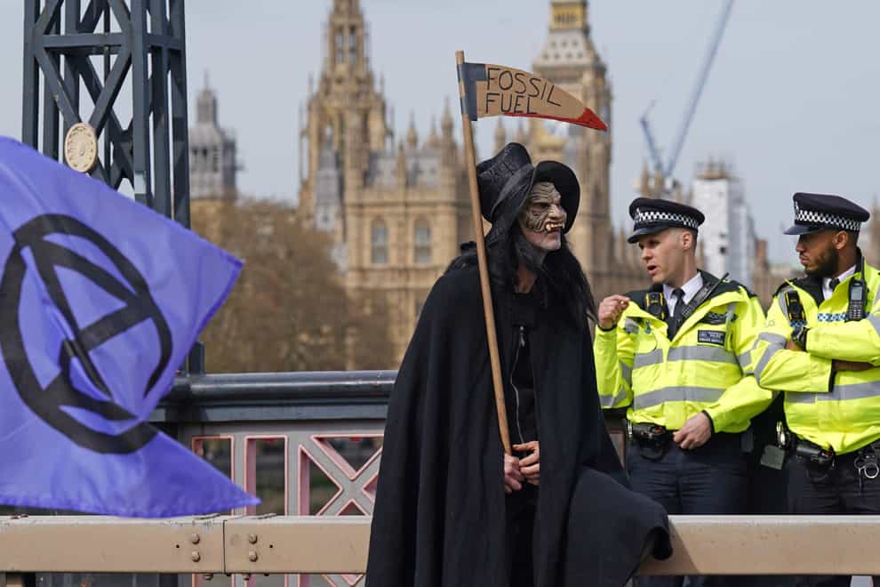 Activists from Extinction Rebellion blocking Lambeth Bridge in central London (Yui Mok/PA)