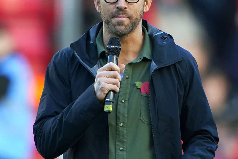 Wrexham owner Ryan Reynolds speaks to fans at the Racecourse Ground (PA)