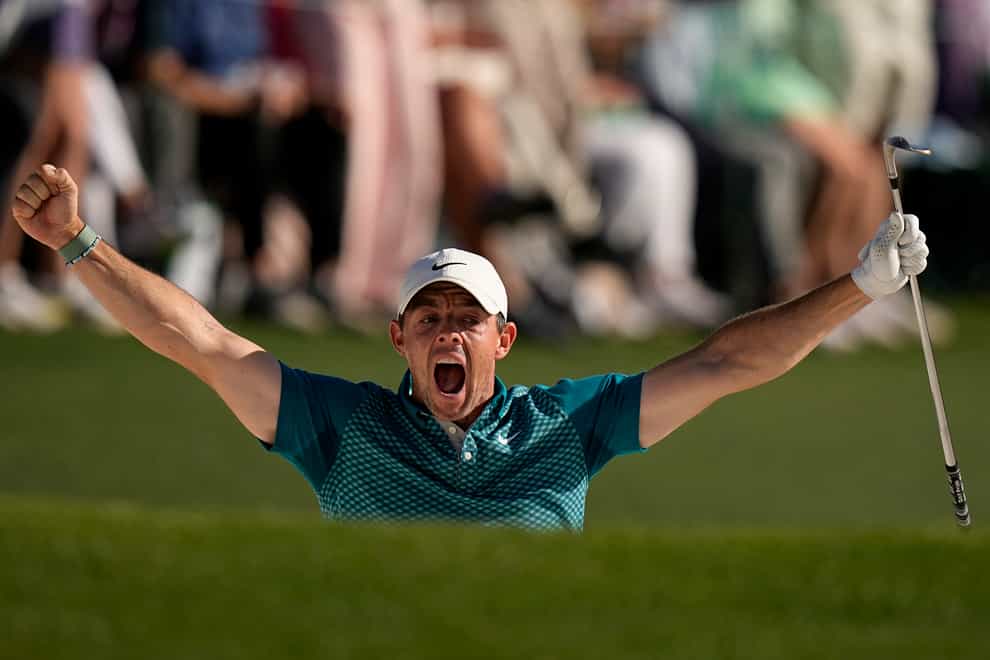 Rory McIlroy reacts after holing out from the bunker for a birdie on the 18th to finish second in the Masters (David J Phillip/AP)