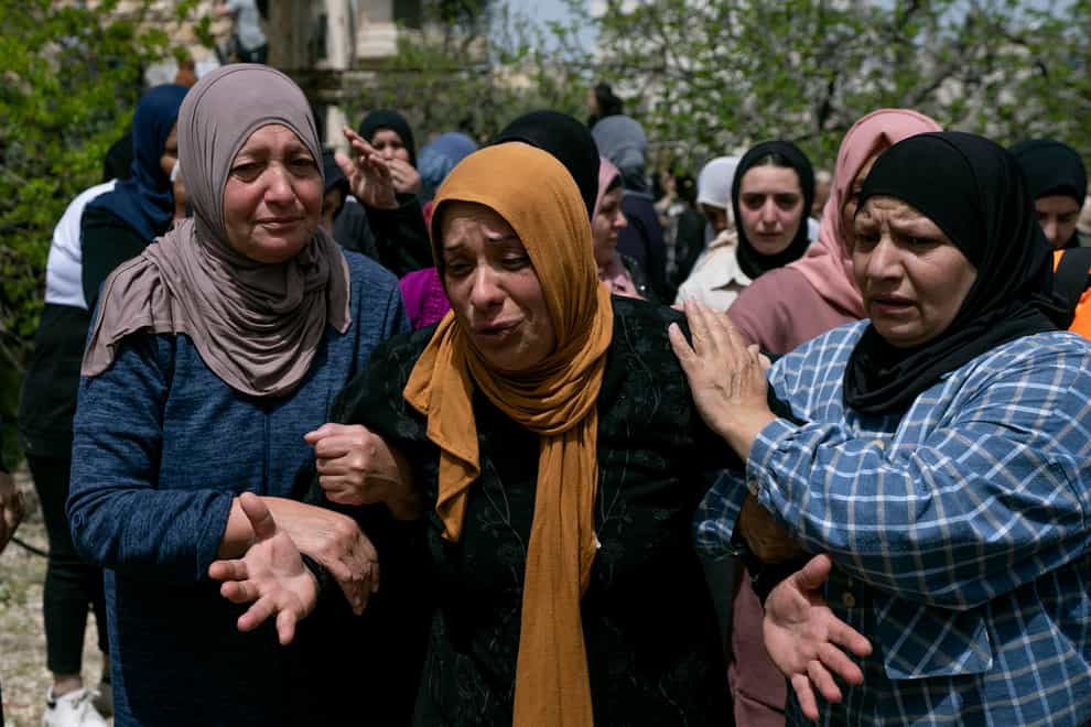 Palestinian Fatima Sbeih, mother of of 21-year-old Muhammad Ali Ahmed Ghoneim, who was killed Sunday by the Israeli army, cries during his funeral in the West Bank village of Al-Khader, south of Bethlehem, Monday, April 11, 2022 (Nasser Nasser/AP)
