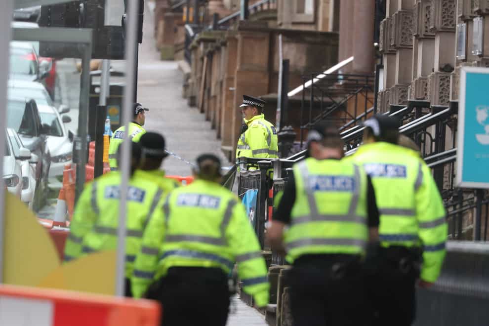 Police officers at the scene outside the Park Inn hotel in West George Street, Glasgow, where Badreddin Abadlla Adam stabbed six people (Andrew Milligan/PA)