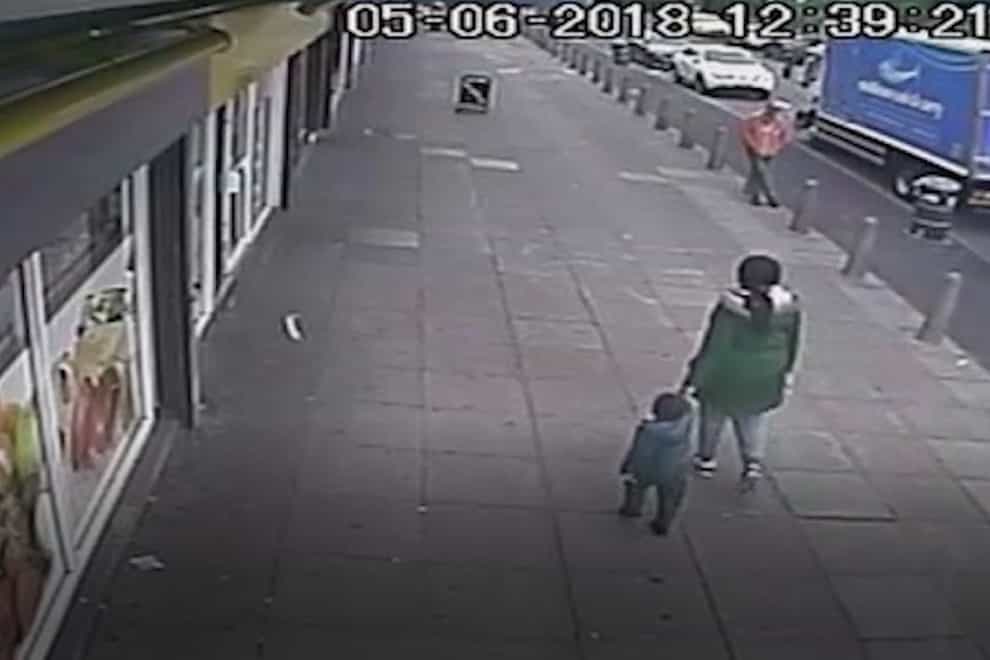 CCTV showing three-year-old Kemarni Watson Darby walking with his mother Alicia Watson past shops near her home in West Bromwich just hours before his murder (West Midlands Police/PA)
