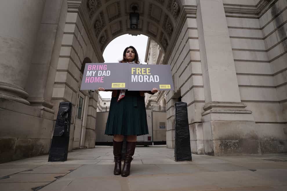 Roxanne Tahbaz holds a placard for her father Morad Tahbaz, who is jailed in Iran, during a protest outside the Foreign Office (Stefan Rousseau/PA)