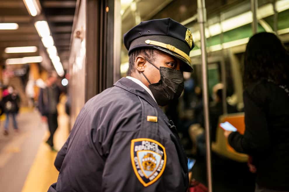 NYPD officers patrol the subway (John Minchillo/AP)