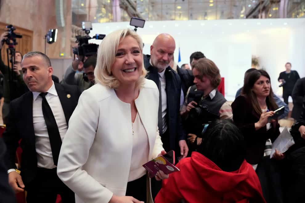French far-right leader Marine Le Pen leaves after a press conference in Paris (Francois Mori/AP)