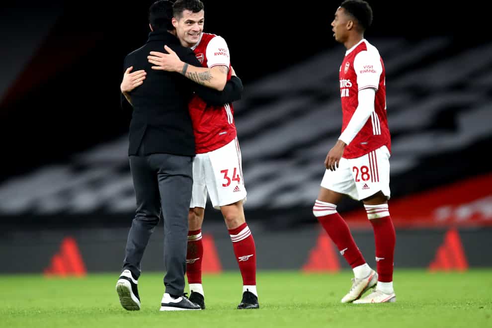 Granit Xhaka hugs Arsenal manager Mikel Arteta (Julian Finney/PA)