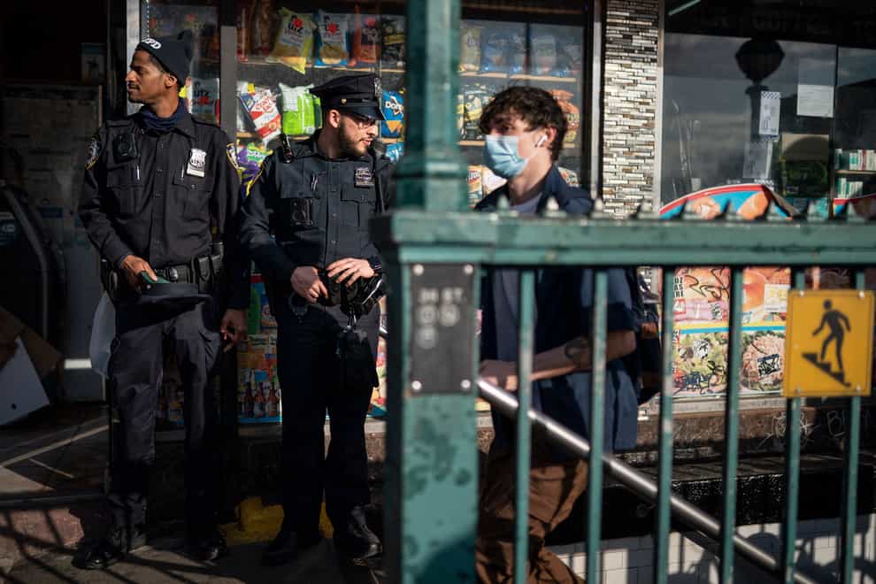 NYPD officers guard the entrance to the 36th Street subway station (John Minchillo/AP)