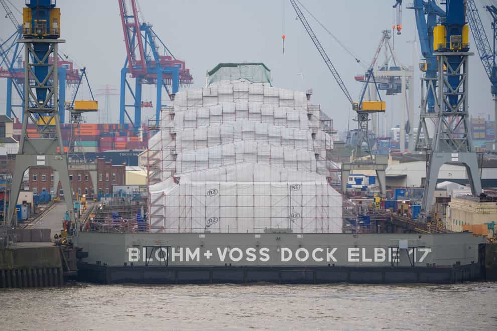 The luxury yacht Dilbar lies completely covered in the Blohm+Voss dock Elbe 17 in Hamburg, Germany (Jonas Walzberg/dpa via AP)