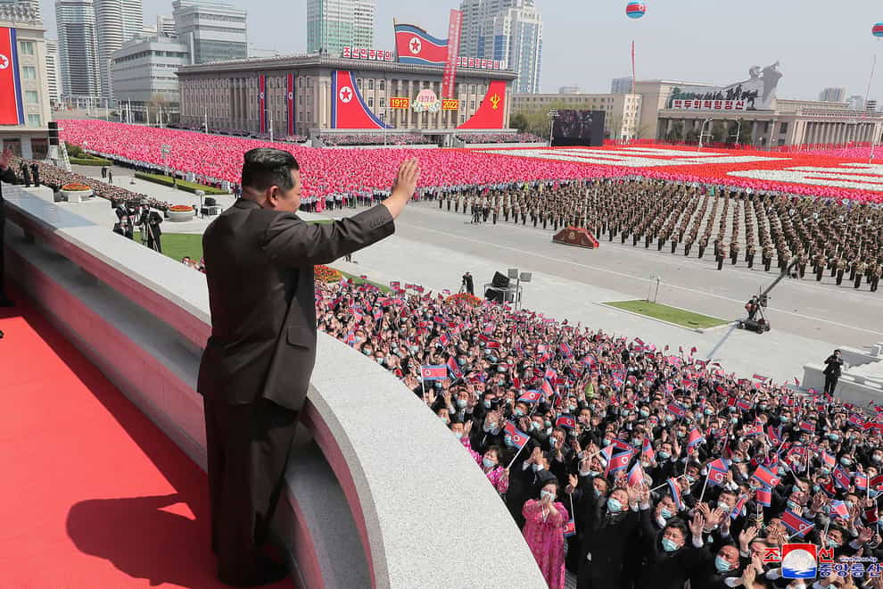 North Korean leader Kim Jong Un waves from a balcony (Korean Central News Agency/Korea News Service via AP)