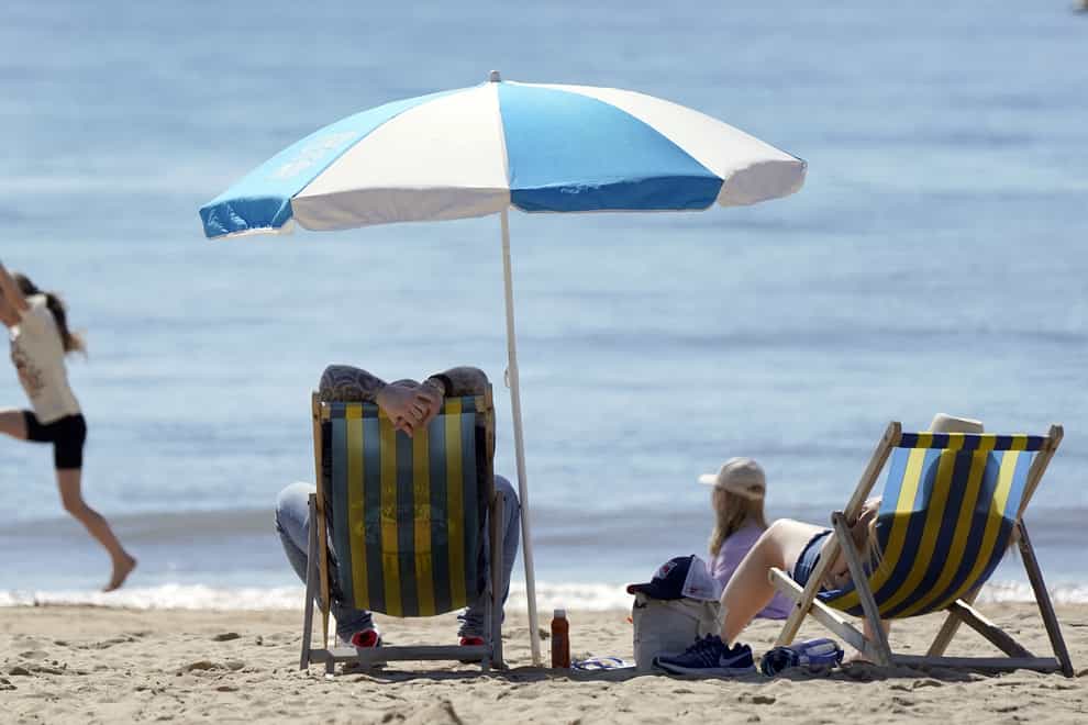 People enjoy the warm weather on Bournemouth beach (Andrew Matthews/PA)