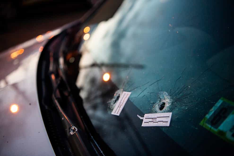 Bullet holes in a nearby parked car (Shane Dunlap/Pittsburgh Tribune-Review/AP)