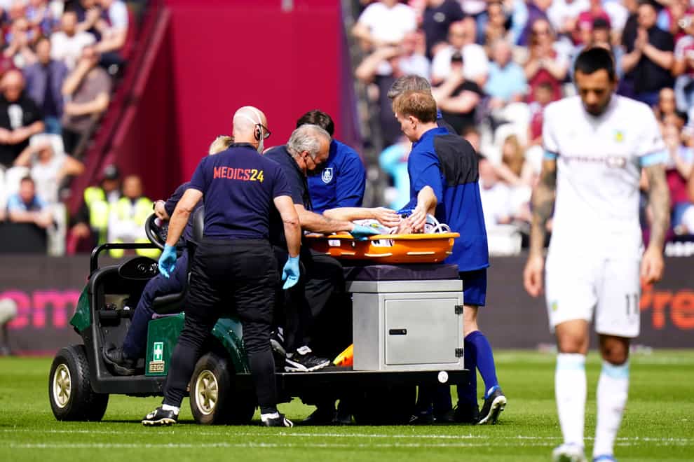 Burnley’s Ashley Westwood leaves the pitch on a stretcher (Adam Davy/PA).