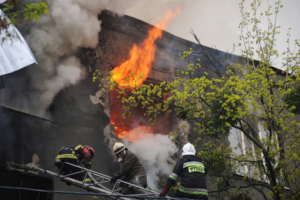 Firefighters work to extinguish a fire at an apartment building after a Russian attack in Kharkiv( Andrew Marienko/AP)