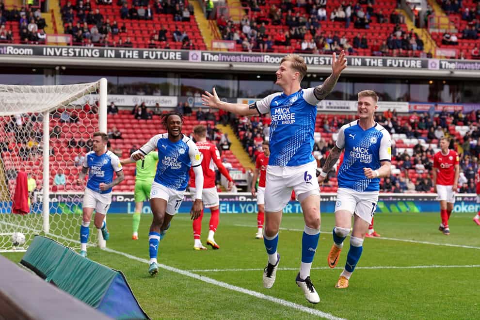 Frankie Kent (second from right) celebrates scoring Peterborough’s second goal in a 2-0 win at Barnsley (Martin Rickett/PA Images).