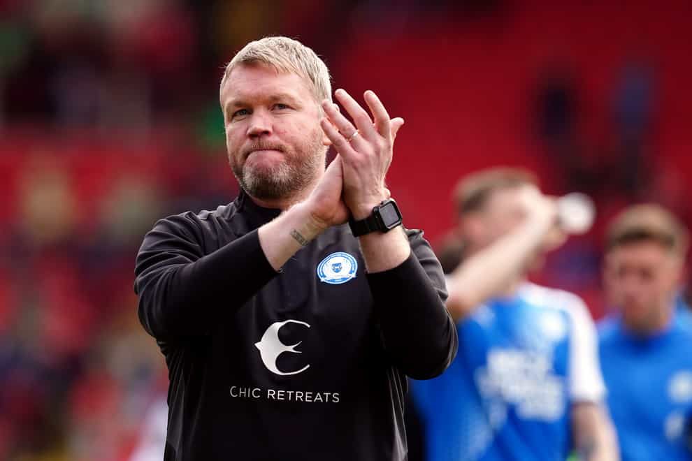 Peterborough manager Grant McCann applauds the visiting fans after his side’s 2-0 win at Barnsley (Martin Rickett/PA Images).