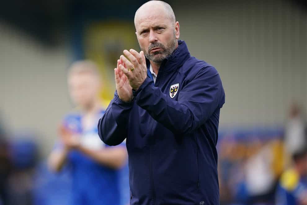 AFC Wimbledon manager Mark Bowen applauds the home fans after the 1-1 draw with Wycombe (Yui Mok/PA Images).