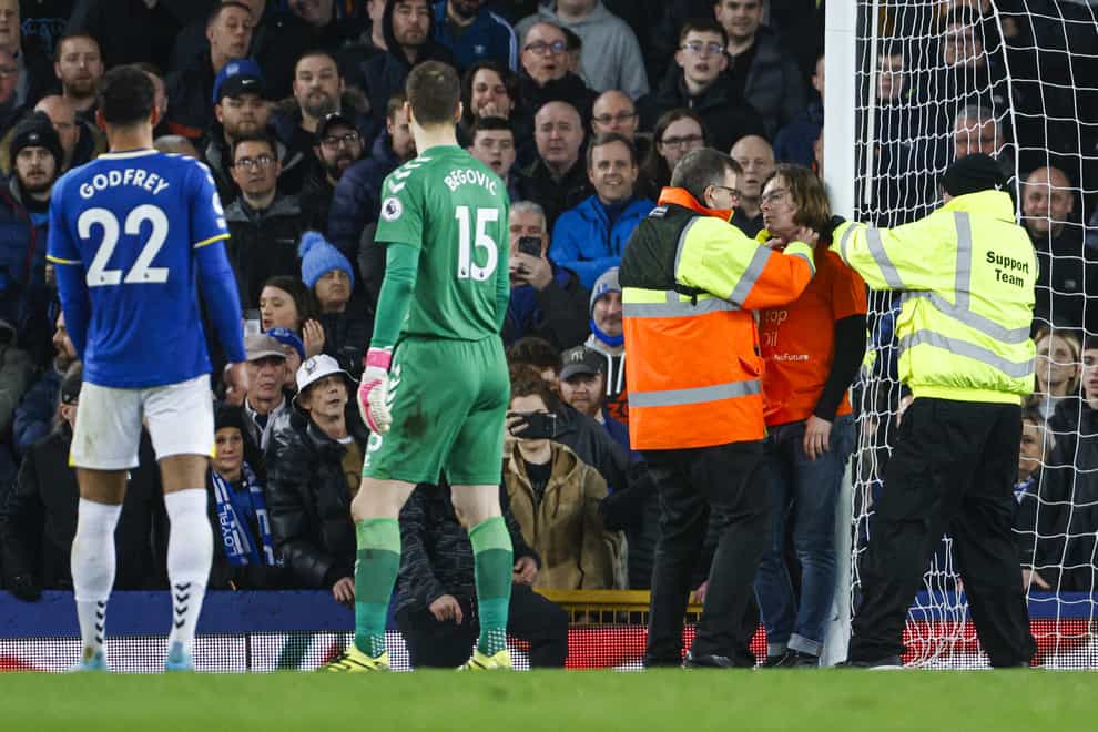 A protester ties himself to the goal frame during the match at Goodison Park (Richard Sellers/PA)