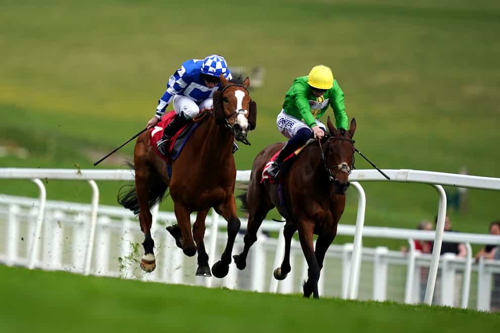 Soto Sizzler and Ryan Moore (left) on their way to winning the City And Suburban Handicap (John Walton/PA)