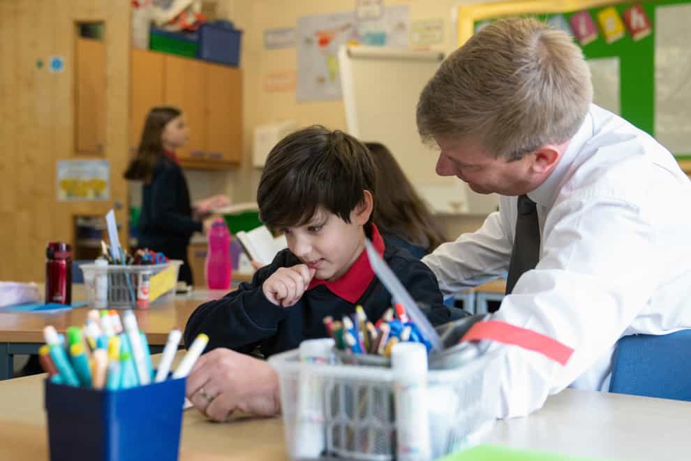 Ukrainian refugee Alikhan Yusupov, 10, with teacher Mr Gardiner during his first day at Caldecote Primary School after his family fled their home in Kharkiv, Ukraine and moved to the village of Caldecote in Cambridgeshire. (Joe Giddens/ PA)