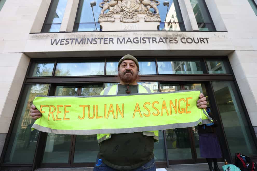 A supporter of WikiLeaks founder Julian Assange protests outside Westminster Magistrates’ Court in London (James Manning/PA)